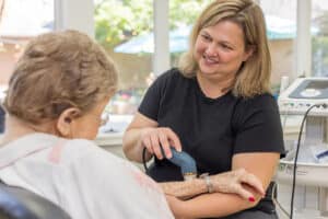 A rehab therapist with a resident in the rehab gym at Circleville Post-Acute