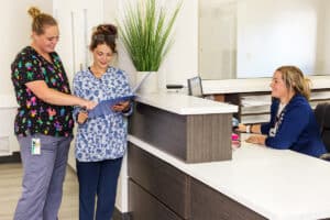 Two nurses in the hallway at the nurse's station at Circleville Post-Acute