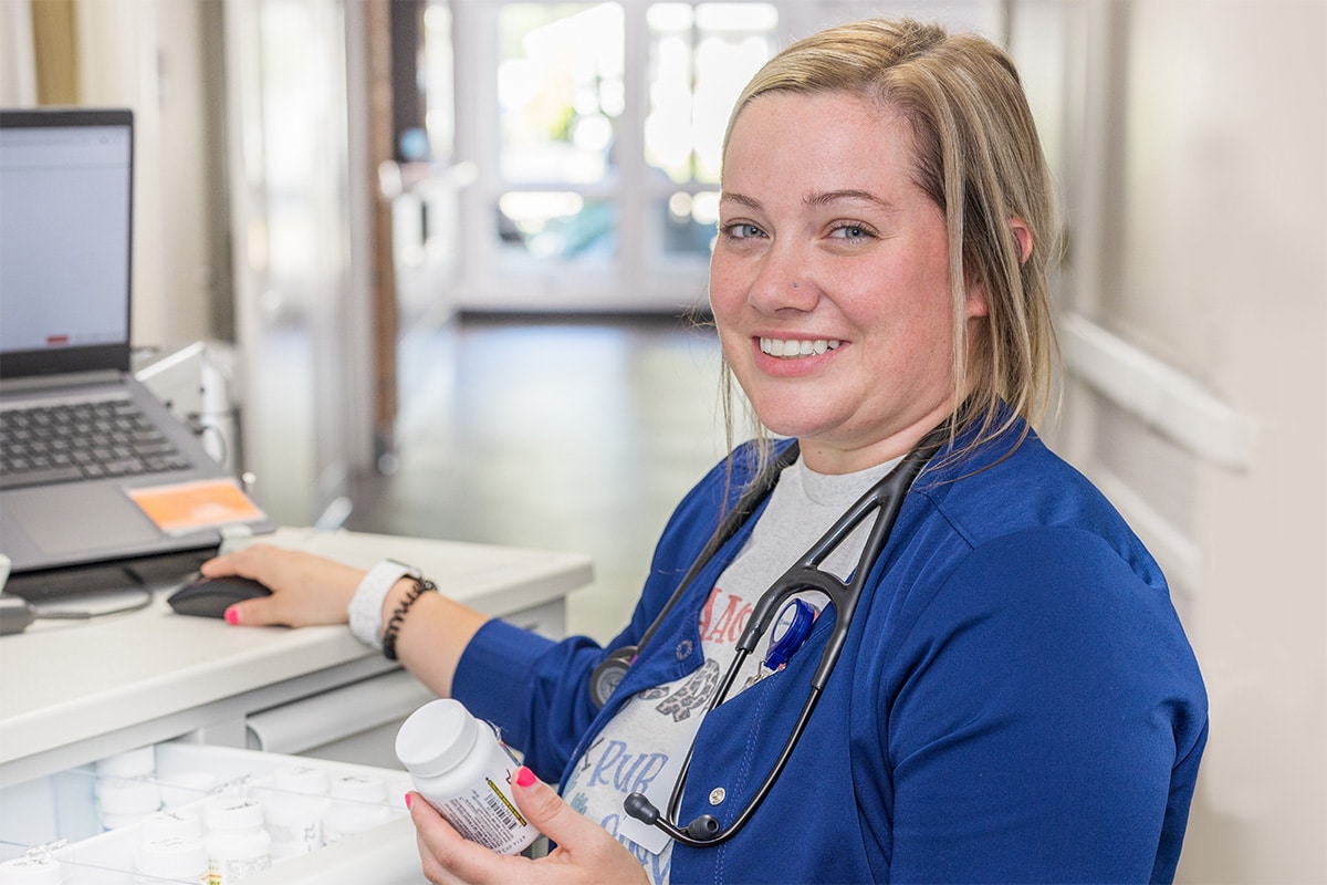 A nurse in the hallway at the nurse's cart at Circleville Post-Acute