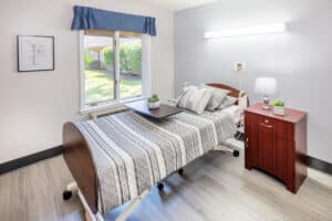 A semi-private resident room with a window at Circleville Post-Acute