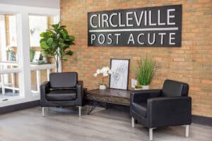 Front entrance lobby and soft seating on wooden floors at Circleville Post-Acute